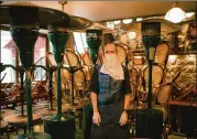  ?? DMITRY KOSTYUKOV / NEW YORK TIMES ?? An employee stands in an empty bistro Monday in Paris. Owner Xavier Denamur was among thousands of business owners trying to manage the chaos and help staff while seeking how to stay afloat.