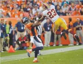  ?? Joe Amon, Denver Post file ?? Washington Redskins cornerback DeAngelo Hall intercepts a pass intended for Broncos wide receiver Demaryius Thomas during a game in 2013.