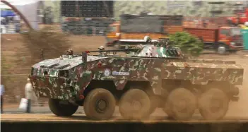  ??  ?? (Top) Defence Minister Manohar Parrikar at the Defexpo 2016; (middle) Main Battle Tank Arjun Mk II and (above) Armoured Fighting Vehicle (Wheeled) demo at the Defexpo 2016.