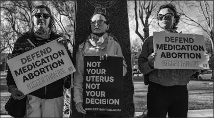  ?? DAVID ERICKSON / ASSOCIATED PRESS FILE (2023) ?? Three members of the Women’s March group protest in support of access to abortion medication March 15, 2023, outside the Federal Courthouse in Amarillo, Texas.