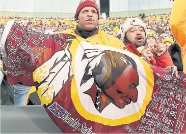  ??  ?? IT’S ALL IN THE NAME: A Washington Redskins fan unfurls a flag during a game last season.