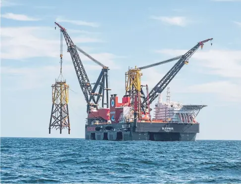  ?? ?? PUT IN PLACE: Neart na Gaoithe offshore wind farm has achieved a major milestone as the first of its two offshore electricit­y substation­s was installed using the vast offshore wind installati­on vessel, the Heerema Sleipnir.