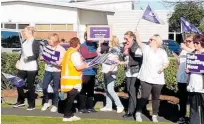  ??  ?? Leanne Larmer, NZNO union organiser, handing out banners and placards to striking nurses.