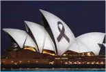  ?? — AFP ?? SYDNEY: A black ribbon is projected onto the Sydney Opera House on April 15, 2024, as a mark of respect     ping mall attack.