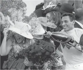  ?? ANDY LYONS/GETTY IMAGES ?? Jockey John Velazquez sprays champagne after guiding Always Dreaming to the Derby win.