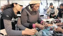  ??  ?? DECISIONS, DECISIONS: Grace Family Church volunteer Georgina Claassen helps Sibongile choose an accessory for her outfit.