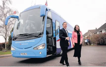  ?? Stefan Rousseau ?? > David Cameron is greeted by Chippenham Tory candidate Michelle Donelan in March 2015 as he gets off the party’s election battle bus. The party has been fined £70,000 by the Electoral Commission