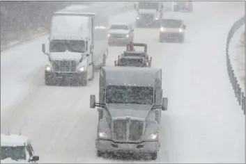  ??  ?? Traffic travels eastbound on Interstate 24 near Paducah, Ky. on Friday. The winter storm, which began with an icy mix before turning to snow, forced schools and businesses to close in Tennessee and Kentucky. Hardest hit were western sections of both states. RYAN HERMENS/THE PADUCAH SUN VIA AP