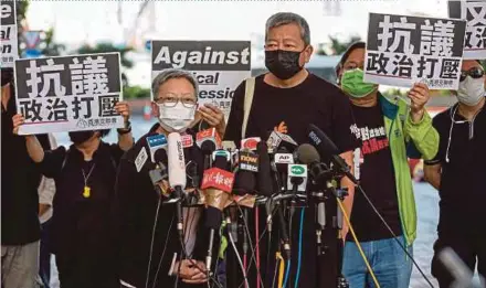  ?? EPA PIC ?? Former lawmakers Lee Cheuk-yan (right) and Cyd Ho talking to reporters outside the West Kowloon court buildings in Hong Kong yesterday.