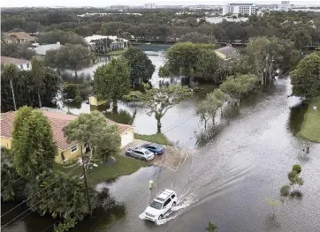  ?? MATIAS J. OCNER mocner@miamiheral­d.com ?? A car drives in Plantation on Nov. 9 after Tropical Storm Eta. The governors of Florida’s Citizens Property Insurance are looking for a higher rate hike while the legislatur­e is considerin­g a bill that would limit roof claims and attorney fees.