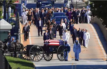  ?? SUSAN WALSH / AP ?? Family members, including Cindy McCain (back center), follow a horse-drawn caisson that carries the casket of Sen. John McCain, R-Ariz., as it proceeds to the United States Naval Academy cemetery.