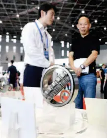  ??  ?? August 8, 2018: An exhibitor (left) introduces his company’s products to clients at the Matchmakin­g Meeting for Exhibitors and Buyers of High- end Intelligen­t Equipment Exhibition Area for the 2018 China Internatio­nal Import Expo at the National Exhibition and Convention Center in Shanghai. by Fang Zhe/ Xinhua