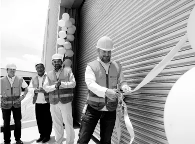  ?? PHOTOGRAPH­ER IAN ALLEN/ ?? Operations Director Fenton Wheelock cuts the ribbon to Celebratio­n Brands’ new warehouse facility, Logic One, located at the Pepsi-Cola Jamaica complex in Kingston, on Tuesday, August 20, 2019. The others (from left) are outgoing Managing Director of Red Stripe Ricardo Nuncio; Anthony Hylton, member of parliament for Western St Andrew; and Managing Director of Celebratio­n Brands Edwin Vaquerano.