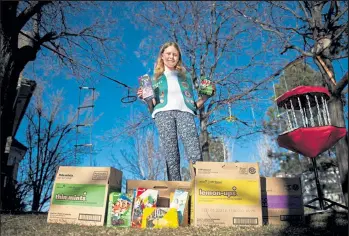  ?? Timothy Hurst / Staff Photograph­er ?? Girl Scout Junior Pearce Lembitz, 11, seen here with boxes of Girl Scout cookies outside her home on Feb. 19 in Superior, believes that donating cookies can “bring a smile” to those who know they are appreciate­d for the good they are doing.