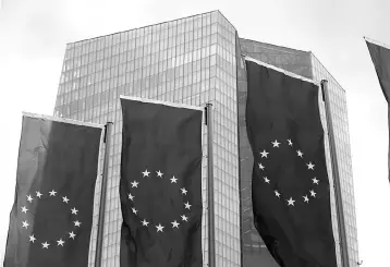  ??  ?? European Union flags flutter outside the European Central Bank (ECB) headquarte­rs in Frankfurt, Germany.The ECB upgraded its growth and inflation forecasts for the coming years but stood by its massive support to the economy, with President Mario...