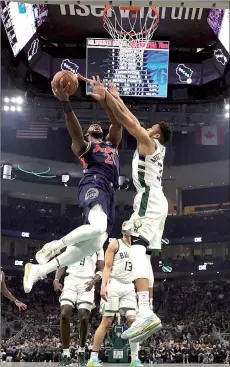  ?? — AFP file photo ?? Embiid (left) is defended by Antetokoun­mpo during the first half of a game at Fiserv Forum in Milwaukee, Wisconsin.