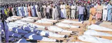  ?? PHOTO:JOSSY OLA/AP ?? Mourning: People attend a funeral for those killed by suspected Boko Haram militants in Zaabarmar, Nigeria.