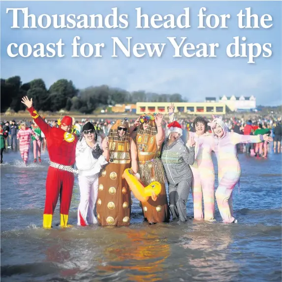  ??  ?? > Friends in fancy dress at the Barry Island New Year’s Day Swim at Whitmore Bay. The sun came out after 2018 arrived with downpours