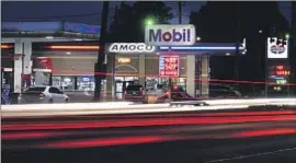  ?? Paul Sancya Associated Press ?? GASBUDDY.COM analyst Patrick De Haan says prices are likely to drop below $5 in L.A. County and statewide, barring unforeseen issues, “but it will take time.”