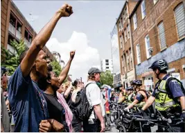  ?? ERIN SCHAFF / THE NEW YORK TIMES ?? Protesters chant Sunday in Charlottes­ville, Va., as they demand police give them access to a memorial for Heather Heyer, who was killed a year ago during a Unite the Right rally.