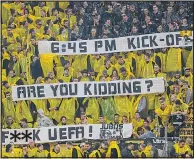  ??  ?? FURY: Dortmund fans vent their anger at UEFA