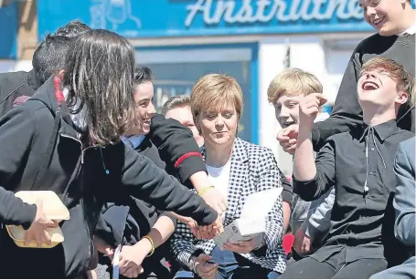  ?? Picture: PA. ?? First Minister Nicola Sturgeon shares chips with schoolchil­dren on a general election campaign visit to Anstruther.