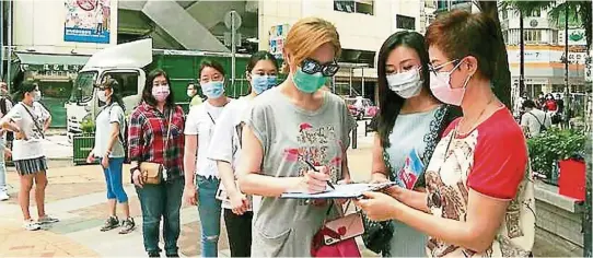  ?? — China Daily ?? People’s support: Residents line up to sign a petition supporting the national security legislatio­n for Hong Kong. Hong Kong’s violent riot scene may be a thing of the past once the security law is implemente­d.