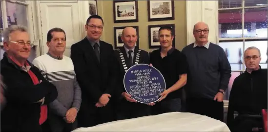  ??  ?? Relatives of WW1 hero Martin Doyle at the unveiling of a new plaque in the Tholsel, New Ross (from left): Bobby Dunphy, Dick O’Neill, Cllr Michael Sheehan, Cathaoirle­ach John Fleming, Leighton Thomas, Myles Courtney of New Ross Street Focus, and Padraig Ryan.