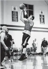  ??  ?? The Rev. Ryan Stawaisz shoots during practice. The game is set for March 6.