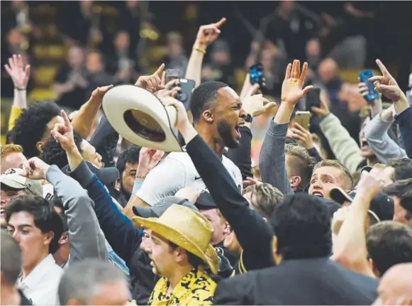  ?? Jeremy Papasso, Daily Camera ?? Colorado’s Dallas Walton, a freshman center, celebrates with fans Thursday night after the Buffaloes pulled off a 90-81 overtime upset of fourth-ranked Arizona State in a Pac-12 game at the Coors Events Center in Boulder. The Buffaloes improved to 9-6...
