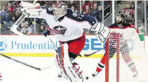  ?? — GETTY IMAGES ?? Columbus goalie Sergei Bobrovsky bats at the puck with his blocker during Sunday’s 4-1 win over the New Jersey Devils.