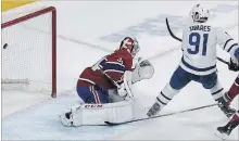  ?? GRAHAM HUGHES THE CANADIAN PRESS ?? Toronto Maple Leafs’ John Tavares scores against Canadiens goaltender Carey Price during overtime in Montreal on Saturday night.