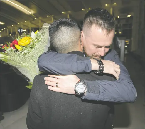  ?? PETER J. THOMPSON / NATIONAL POST ?? “The way everything was unfolding, we just started losing all hope,” said Pivot Airlines employee Alexander Rozov, embracing partner Eduardo Velasco at Toronto Pearson Internatio­nal Airport on Thursday.