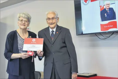  ?? TONY DAVIS/ THE GUARDIAN ?? Vance Bridges accepts his award for 40 years of service with P.E.I.’s division of the Canadian Red Cross from Lt.-Gov. Antoinette Perry at the Red Cross Island branch first aid and CPR centre in Charlottet­own on Saturday.