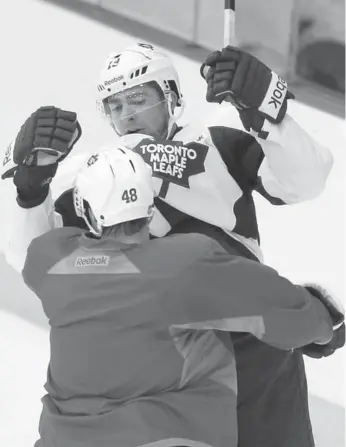  ?? STEVE RUSSELL/TORONTO STAR ?? The Leafs’ Ryan Hamilton (48) tangles with teammate Joffrey Lupul at practice Friday. Hamilton, along with Joe Colborne, far left, and Jake Gardiner, could find themselves in the lineup when the puck drops for Game 2 Saturday.