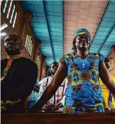  ?? AFP ?? A woman cries as she attends a Catholic mass in Kinshasa on Wednesday, held to mourn victims of the violent clashes of the last few days that left scores dead.