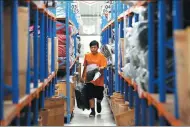  ?? REUTERS ?? A worker fills an order at the Lazada’s warehouse in Jakarta, Indonesia.