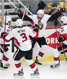  ?? GENE J. PUSKAR/THE ASSOCIATED PRESS ?? Ottawa Senators forward Bobby Ryan, centre, celebrates with teammates after scoring the game winner in overtime against the Pittsburgh Penguins on Saturday in Pittsburgh. The Senators won 2-1 to take a 1-0 lead in the series. Game 2 is on Monday.