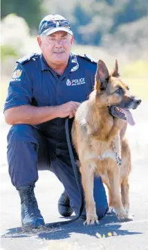  ?? Photo/ Michael Cunningham ?? Senior Constable Ross Clarke and detector dog Archie in 2013.