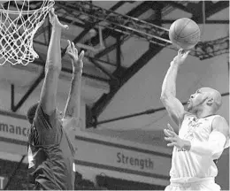  ?? PHELAN M. EBENHACK/ASSOCIATED PRESS ?? W. Va. guard Jevon Carter, who had 16 points, goes up to shoot against UCF’s Tacko Fall.