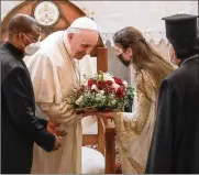  ??  ?? Pope Francis is welcomed upon his arrival at the Sayidat al-Nejat (Our Lady of Salvation) Cathedral in Baghdad on Friday. He urged the country’s dwindling number of Christians to stay put and help rebuild the country.