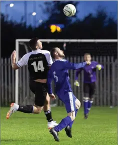  ??  ?? Shane Doyle of Newtown and Ashford’s Mick Taylor battle for the ball.