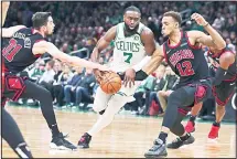  ??  ?? Boston Celtics guard Jaylen Brown (7) tries to thread between Chicago Bulls guard Tomas Satoransky (31) and forward Daniel Gafford (12) on a drive to the basket during the first half of an NBA basketball game in
Boston, on Jan 13. (AP)