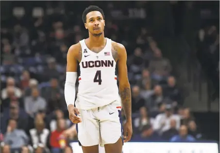  ?? Jessica Hill / Associated Press ?? UConn’s Jalen Adams walks up the court during the second half against Memphis Sunday in Storrs.