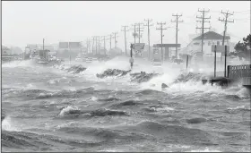  ?? AP/TOM COPELAND ?? Water from Roanoke Sound pounds the Virginia Dare Trail on Saturday in Manteo, N.C., as Tropical Storm Hermine passes the Outer Banks.