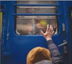  ?? ?? Stanislav says goodbye to his 2-year-old son, David, and wife, Anna, on March 3 after they boarded a train that would take them to Lviv, from the station in Kyiv, Ukraine. Stanislav stayed to fight as his family sought refuge in a neighborin­g country. (AP/Emilio Morenatti)