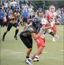  ?? Graham Thomas/Herald-Leader ?? Colcord (Okla.) sophomore Cooper Mott tackles Kansas (Okla.) junior Max Noe during the first half of the annual Battle of south Delaware County on Thursday, Sept. 1, at Dee Neel Stadium. Colcord defeated Kansas 46-33 for its ninth straight victory in the series between the two schools.