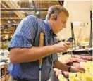  ?? AMY DAVIS/BALTIMORE SUN ?? Paul Schroeder of Silver Spring, who is blind, uses the Aira app while shopping at Wegmans. The grocer is the first in the country to offer free access to the app.