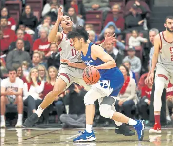  ?? TONY AVELAR — THE ASSOCIATED PRESS ?? BYU’s Elijah Bryant, right, collides with Stanford’s Dorian Pickens and is called for an offensive foul Wednesday.