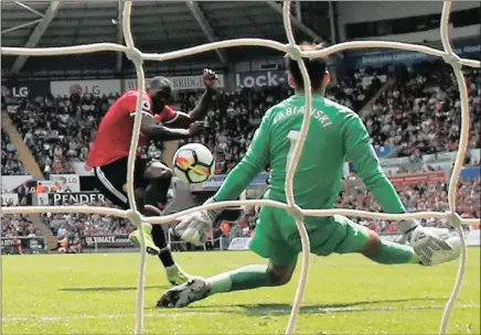  ??  ?? BANG ON: Romelu Lukaku scores Manchester United’s second goal during yesterday’s 4-0 win over Swansea City at the Liberty Stadium.